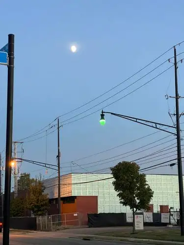 Moon above, green glow below.